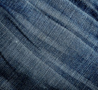 Wrinkled worn jeans texture. Background. Close up