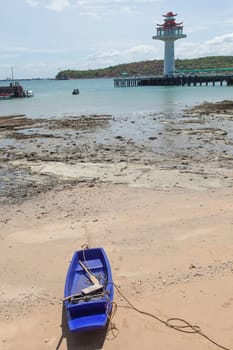 Wooden fishing boat moored on the beach. Fishing dock area of the island.
