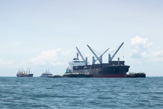 large cargo ship. Moored offshore. Transport near the docks.
