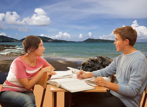 Students girl and the guy read the literature and dream of the sea . Isolated on sea background