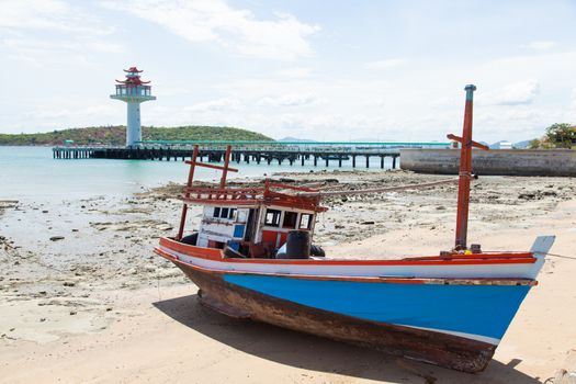 Wooden fishing boat moored on the beach. Fishing dock area of the island.