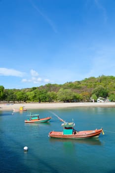 Small fishing boat. Moored in the sea beach is a small fish.