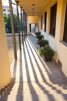 passage, gallery with metal columns and shadows