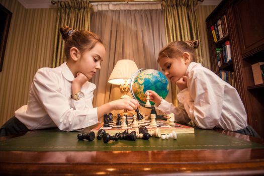 Small girls playing chess