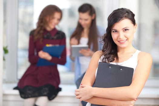 Portrait of pretty girl looking at camera in college