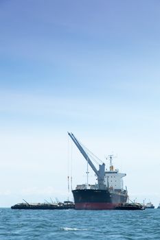 large cargo ship. Moored offshore. Transport near the docks.