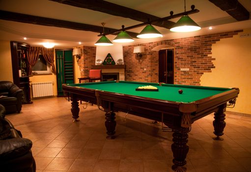 Photo of luxurious room with billiard table