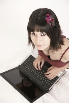 A colorful woman works on the laptop
