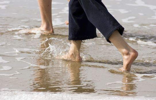Feet walk down the Beach