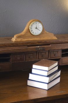 Some books sit on the Vintage Roll Top Desk