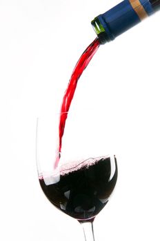 Red Wine falls into a stemmed wine glass