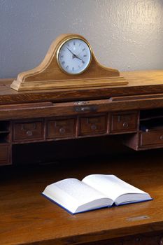 A book sits on the Vintage Roll Top Desk
