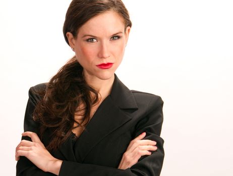 An attractive woman stands arms crossed in her Business Suit