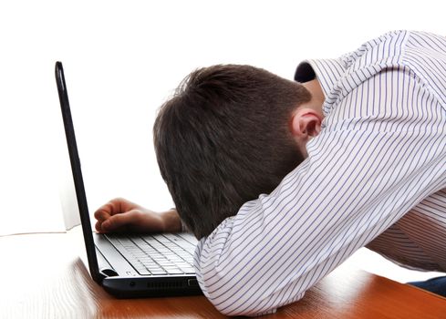 Tired Young Man sleeping on the Laptop on the White Background