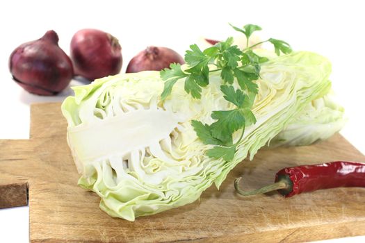 sweetheart Cabbage with board on a light background