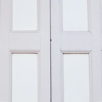Old wooden door is the door hinge light gray.