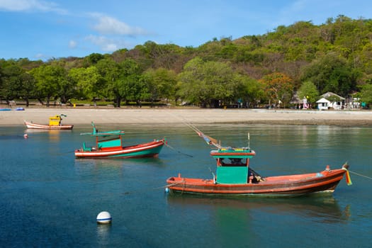 Small fishing boat. Moored in the sea beach is a small fish.