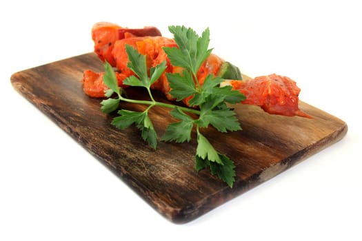 raw, marinated skewered meat in front of white background