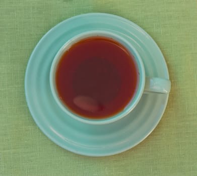 Green cup of tea. View from above. toning