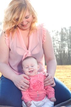 Mother and daughter on a sunny day in the field