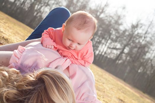 Mother and daughter on a sunny day in the field