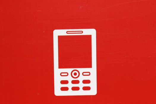 On a red background shows white mobile phone