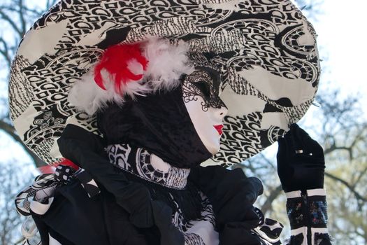 Black and white female with big hat at the 2014 venetian carnival of Annecy, France