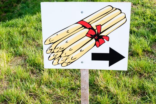 Asparagus for sale - sign pointing to a sales booth on the right