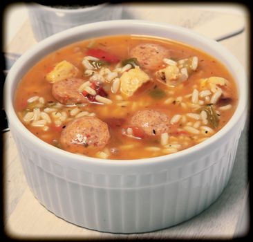 Bowl of Cajun Spicy Chicken and Sausage Gumbo Soup at Table
