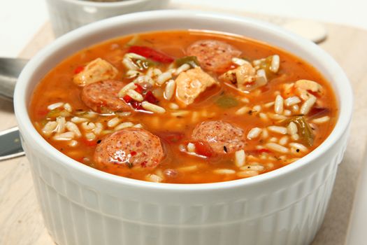 Bowl of Cajun Spicy Chicken and Sausage Gumbo Soup at Table