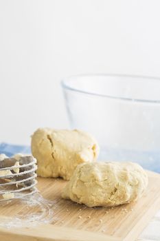 Two balls of cookie dough on cutting board with copy space at top.