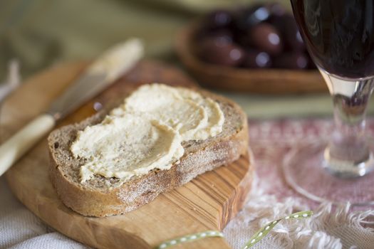 Creamy hummus spread on healthy whole wheat toast