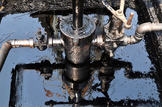 old pumpjack pumping crude oil from oil well