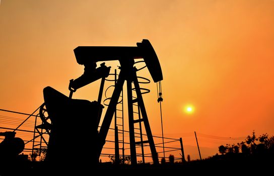 old pumpjack pumping crude oil from oil well
