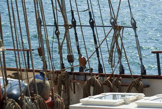 Old traditional wooden sailing boat sails and rigging on sea