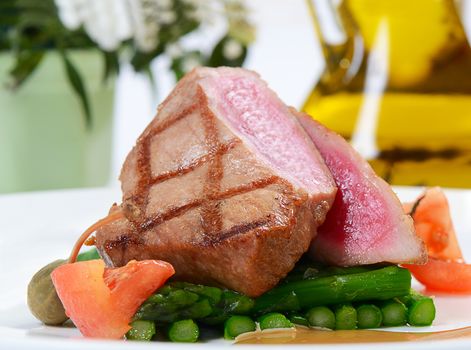 Tuna a grill with an asparagus close-up