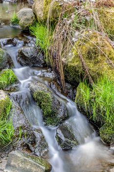 Falls on the small mountain river in a wood in spring