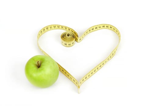 green apple with a measuring tape and heart symbol isolated on white background 