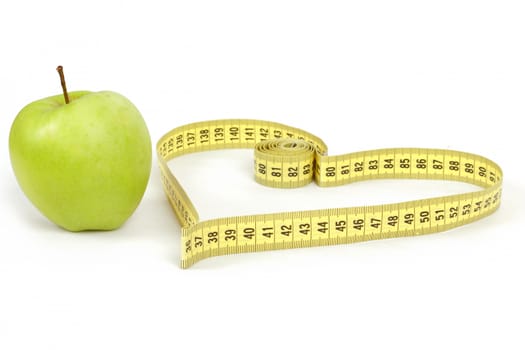 green apple with a measuring tape and heart symbol isolated on white background 