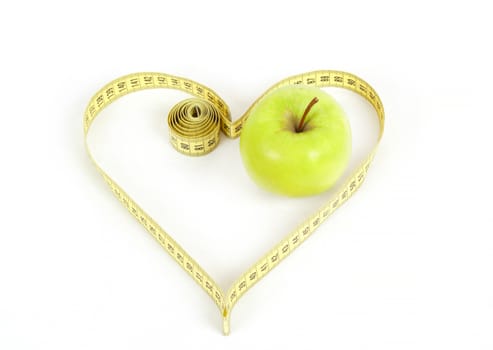 green apple with a measuring tape and heart symbol isolated on white background 