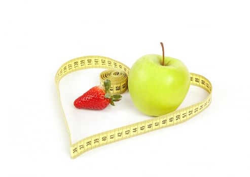 green apple and strawberry with a measuring tape and heart symbol isolated on white background 