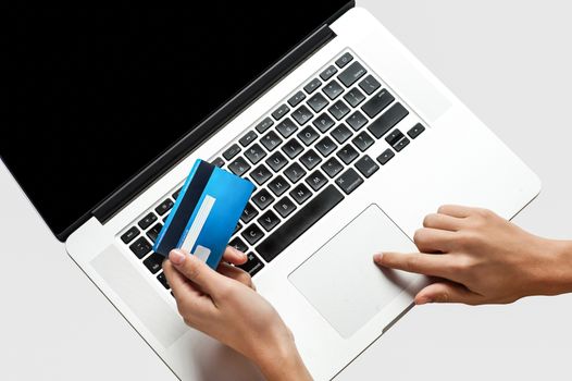 Woman's hand entering credit card information into a laptop