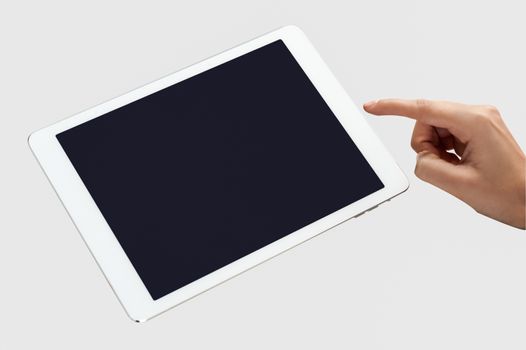 Female hand points on blank tablet pc device