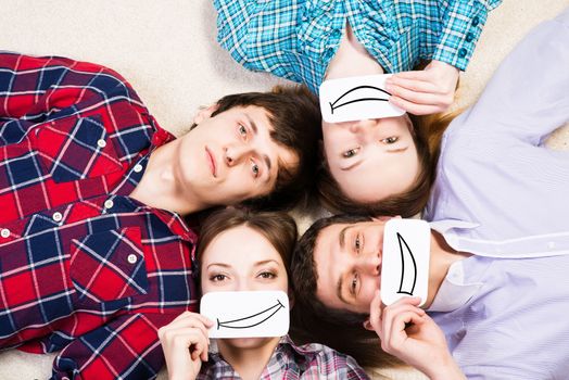 four young men lie together, applied to the face card with smiles