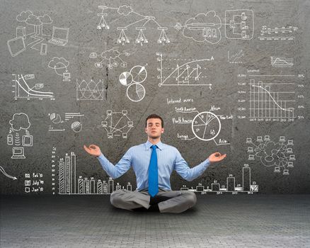 image of a business man meditating on floor, wall charts and diagrams are drawn