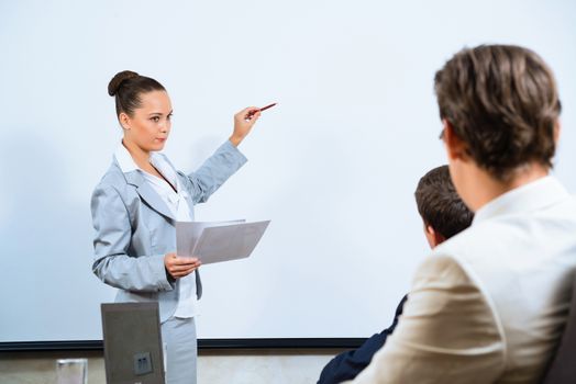 image of a Business woman showing a presentation to colleagues