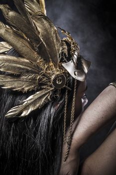 Sensual young woman with golden mask jewelry