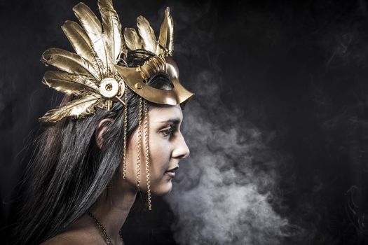 Sensual young woman with golden mask jewelry