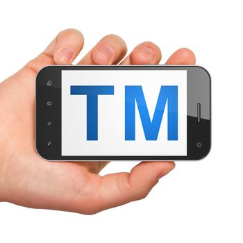 Law concept: hand holding smartphone with Trademark on display. Mobile smart phone on White background, 3d render