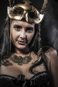 Sensual young woman with golden mask jewelry